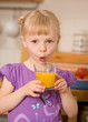little girl with orange juice