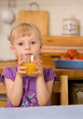 little girl with orange juice