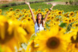 Happy girl between sunflowers