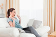 © WavebreakmediaMicro - Joyful woman gambling with her computer while sitting on a sofa