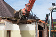 Destruction of a building by a caterpillar crane
