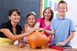© Szasz-Fabian Erika - Students and teacher putting coin into piggy bank