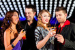 © Kzenon - Group of party people with cocktails in a bar or club having fun