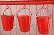 Three old, red fire buckets used to put out fires