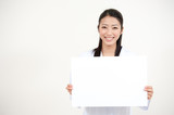 Fototapeta  - beautiful asian nurse holding a blank whiteboard