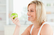 © WavebreakmediaMicro - Young woman looking at green a apple