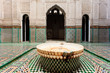 Ornate tiles and fountain in a madrasa