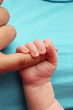 © jojof - Newborn baby clutching mothers finger