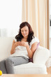 © WavebreakmediaMicro - Woman sitting on a sofa texting