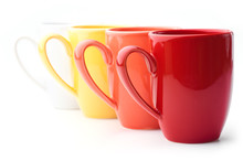 Perspective Row Of Bright Colorful Mugs, Red, Orange, Yellow And