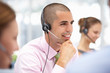© Monkey Business - Young businessman wearing headset