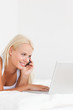 © WavebreakmediaMicro - Portrait of a woman on the phone using a notebook