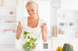 © WavebreakmediaMicro - Gorgeous woman mixing a salad