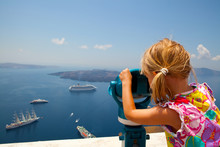 Girl Looking With Binoculars In Thira, Santorini, Greece