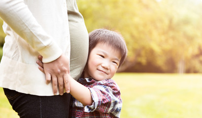 pregnant asian mother and her son