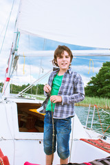 boy sailing on yacht, Trakai, Lithuania