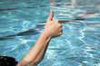 thumb up in the swimming pool