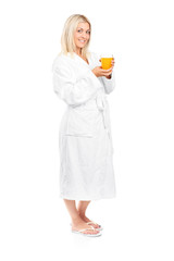 Poster - Young woman in bathrobe drinking orange juice for breakfast