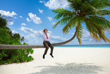 Wall Mural - Happy businessman sitting on the palm and relax