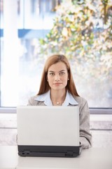 Sticker - Portrait of confident businesswoman with laptop