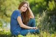 © Nikita Vishneveckiy - beautiful girl sitting on the grass and looking at the camera