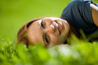 © Nikita Vishneveckiy - girl lying on the grass and smiling