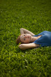 © Nikita Vishneveckiy - girl lying on the grass and smiling