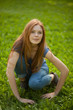 © Nikita Vishneveckiy - beautiful red-haired girl sitting on grass