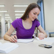© lightpoet - in the library - pretty female student with books