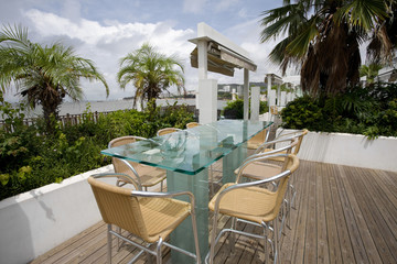 Wall Mural - Beach cafe with  tables and chairs placed at the sea waterfront