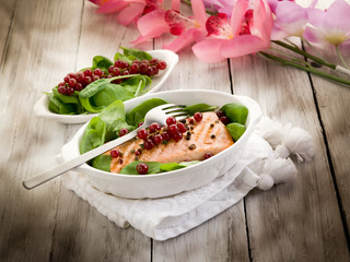 Wall Mural - grilled salmon with redcurrants and fresh spinach