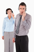 Portrait Of Coworkers Speaking Through Headsets