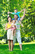 © .shock - happy young couple with their children have fun at park