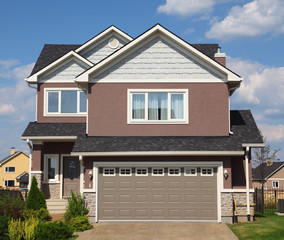 New two-storied white-brown brick cottage with beige garage