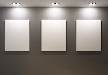 Empty frames on grey wall in gallary of  museum interior