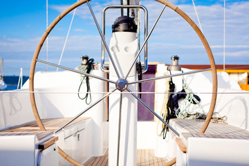 Steering wheel on a boat with empty seats