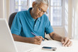 © REB Images/Blend Images - Mixed race man paying bills online
