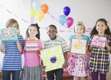 Children At Birthday Party Holding Gifts