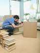 © Erik Isakson/Blend Images - Caucasian man writing on cardboard packing box