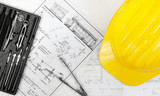 Fototapeta  - Construction plans with yellow helmet on it