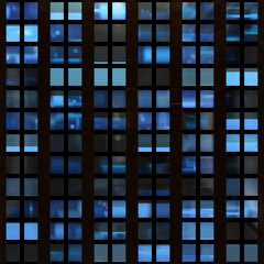 Seamless texture of modern building windows at night