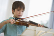© JGI/Tom Grill/Blend Images - Mixed race boy playing violin