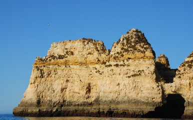 Wall Mural - Caves in the cliffs yellow in Lagos in the Algarve Portugal