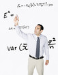 © PBNJ Productions/Blend Images - Hispanic businessman writing formula on clear board