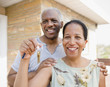 © JGI/Jamie Grill/Blend Images - Proud Black couple holding keys to new home