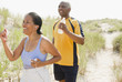 © JGI/Jamie Grill/Blend Images - Black couple exercising on beach