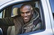 © Steve Prezant/Blend Images - Smiling African American man driving car