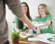 © JGI/Jamie Grill/Blend Images - Teenage girls handing recycling brochure to man