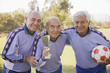 © REB Images/Blend Images - Senior Chilean soccer players holding trophy and soccer ball