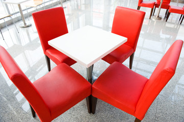 Wall Mural - four red chairs at a table